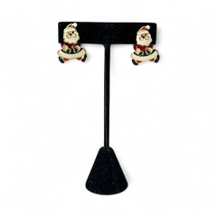 Vintage AIM Santa earrings with red, white, and black enamel, signed with copyright mark, featuring movable head and pierced stud design.