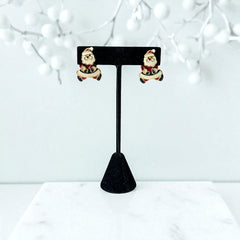 Vintage AIM Santa earrings with red, white, and black enamel, signed with copyright mark, featuring movable head and pierced stud design.