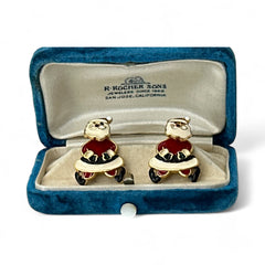 Vintage AIM Santa earrings with red, white, and black enamel, signed with copyright mark, featuring movable head and pierced stud design.