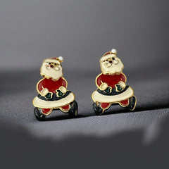 Vintage AIM Santa earrings with red, white, and black enamel, signed with copyright mark, featuring movable head and pierced stud design.