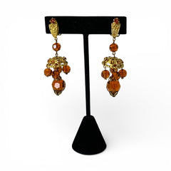 Vintage gold-tone clip-on earrings with honey topaz faceted crystals and ornate filigree dangle design.