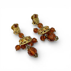 Vintage gold-tone clip-on earrings with honey topaz faceted crystals and ornate filigree dangle design.