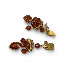 Vintage gold-tone clip-on earrings with honey topaz faceted crystals and ornate filigree dangle design.