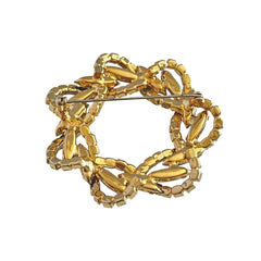 Vintage gold tone wreath brooch with amethyst, peridot, and blue rhinestones, shown in various decorative arrangements.