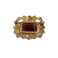 Vintage gold‑tone brooch with an amethyst‑colored rhinestone, faux pearls, and white enamel flowers