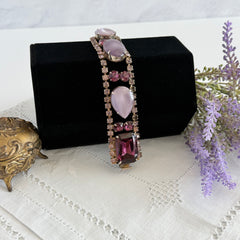 Vintage 1950s bracelet with lavender satin glass cabochons and amethyst rhinestones in prong‑set silver‑tone settings.