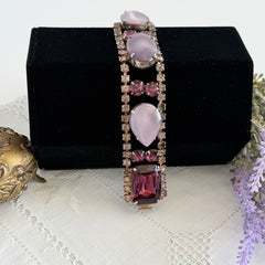 Vintage 1950s bracelet with lavender satin glass cabochons and amethyst rhinestones in prong‑set silver‑tone settings.