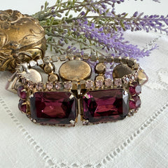 Vintage 1950s bracelet with lavender satin glass cabochons and amethyst rhinestones in prong‑set silver‑tone settings.