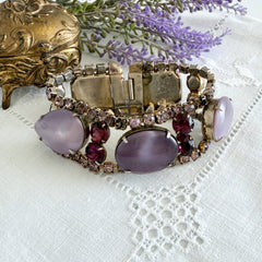 Vintage 1950s bracelet with lavender satin glass cabochons and amethyst rhinestones in prong‑set silver‑tone settings.