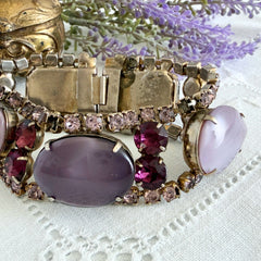 Vintage 1950s bracelet with lavender satin glass cabochons and amethyst rhinestones in prong‑set silver‑tone settings.