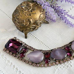 Vintage 1950s bracelet with lavender satin glass cabochons and amethyst rhinestones in prong‑set silver‑tone settings.