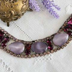 Vintage 1950s bracelet with lavender satin glass cabochons and amethyst rhinestones in prong‑set silver‑tone settings.