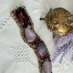 Vintage 1950s bracelet with lavender satin glass cabochons and amethyst rhinestones in prong‑set silver‑tone settings.
