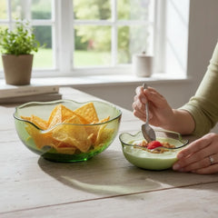 Vintage 1970s Anchor Hocking chip and dip bowl set in avocado green glass. Features sculptural wavy design and glossy finish. Includes large and small bowls in very good condition, ideal for serving or display.
