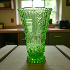 Vintage spring green pressed glass vase with scalloped rim and embossed geometric patterns, shown from various angles to highlight texture and translucence.