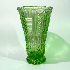 Vintage spring green pressed glass vase with scalloped rim and embossed geometric patterns, shown from various angles to highlight texture and translucence.