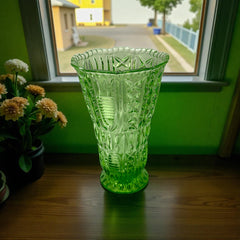 Vintage spring green pressed glass vase with scalloped rim and embossed geometric patterns, shown from various angles to highlight texture and translucence.
