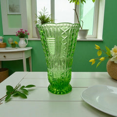 Vintage spring green pressed glass vase with scalloped rim and embossed geometric patterns, shown from various angles to highlight texture and translucence.
