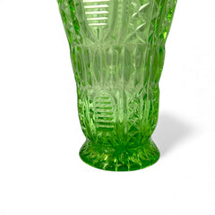 Vintage spring green pressed glass vase with scalloped rim and embossed geometric patterns, shown from various angles to highlight texture and translucence.
