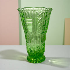 Vintage spring green pressed glass vase with scalloped rim and embossed geometric patterns, shown from various angles to highlight texture and translucence.