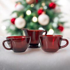 Vintage Anchor Hocking Royal Ruby Red glass creamer and cups set of 3, deep red translucent glass with glossy finish, shown in various angles to highlight design and condition.