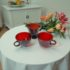 Vintage Anchor Hocking Royal Ruby Red glass creamer and cups set of 3, deep red translucent glass with glossy finish, shown in various angles to highlight design and condition.