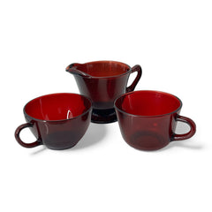 Vintage Anchor Hocking Royal Ruby Red glass creamer and cups set of 3, deep red translucent glass with glossy finish, shown in various angles to highlight design and condition.