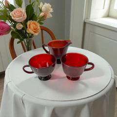 Vintage Anchor Hocking Royal Ruby Red glass creamer and cups set of 3, deep red translucent glass with glossy finish, shown in various angles to highlight design and condition.