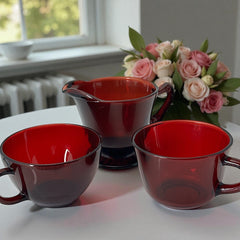 Vintage Anchor Hocking Royal Ruby Red glass creamer and cups set of 3, deep red translucent glass with glossy finish, shown in various angles to highlight design and condition.