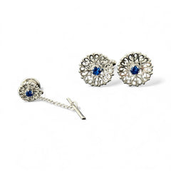 Vintage Anson men’s jewelry set featuring silver-tone round cufflinks and matching tie tack with blue rhinestones and openwork filigree design; presented in original moss green velvet-lined box, all pieces signed and in excellent condition.