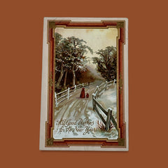 Antique 1910s embossed postcard featuring a snowy path with a person and child walking, framed by gilded orange-brown border; message reads “All Good Wishes for the New Year.