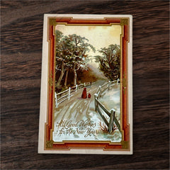 Antique 1910s embossed postcard featuring a snowy path with a person and child walking, framed by gilded orange-brown border; message reads “All Good Wishes for the New Year.