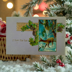 Antique 1912 New Year postcard featuring embossed deer in snowy forest with pinecones and gold gilt, muted lavender background, greeting “A Happy New Year” in capital letters, very good condition with minimal corner wear.