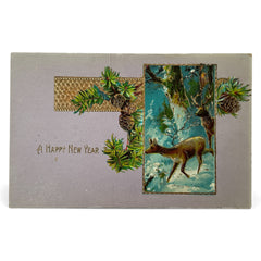 Antique 1912 New Year postcard featuring embossed deer in snowy forest with pinecones and gold gilt, muted lavender background, greeting “A Happy New Year” in capital letters, very good condition with minimal corner wear.