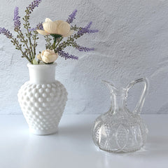 Antique pressed clear glass cruet with diamond pattern and rounded base.