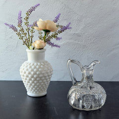 Antique pressed clear glass cruet with diamond pattern and rounded base.