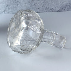 Antique pressed clear glass cruet with diamond pattern and rounded base.
