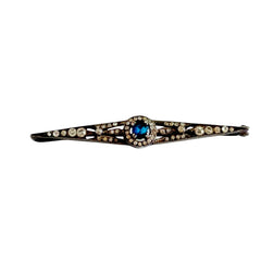 Antique French silver bar brooch with an oval Swiss‑blue topaz at the center, framed by clear stones and delicate openwork detailing.