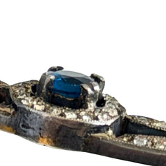 Antique French silver bar brooch with an oval Swiss‑blue topaz at the center, framed by clear stones and delicate openwork detailing.