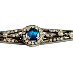 Antique French silver bar brooch with an oval Swiss‑blue topaz at the center, framed by clear stones and delicate openwork detailing.