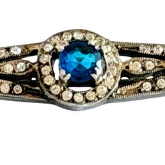 Antique French silver bar brooch with an oval Swiss‑blue topaz at the center, framed by clear stones and delicate openwork detailing.
