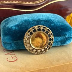 Antique Victorian portrait brooch with lithograph miniature, brass fleur‑de‑lys frame, and celluloid cover.