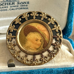 Antique Victorian portrait brooch with lithograph miniature, brass fleur‑de‑lys frame, and celluloid cover.