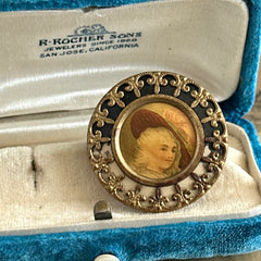 Antique Victorian portrait brooch with lithograph miniature, brass fleur‑de‑lys frame, and celluloid cover.