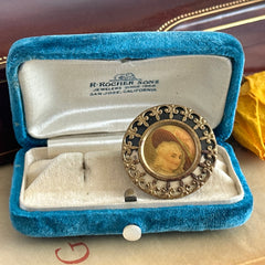 Antique Victorian portrait brooch with lithograph miniature, brass fleur‑de‑lys frame, and celluloid cover.
