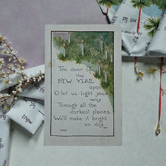 Printed vintage New Year postcard with lit candles among greenery and a poetic verse: “The door of the NEW YEAR opens… We’ll make it bright as day.” Signed F.A. Owen Co., number 506B.