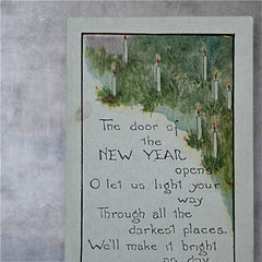 Printed vintage New Year postcard with lit candles among greenery and a poetic verse: “The door of the NEW YEAR opens… We’ll make it bright as day.” Signed F.A. Owen Co., number 506B.