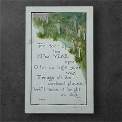 Printed vintage New Year postcard with lit candles among greenery and a poetic verse: “The door of the NEW YEAR opens… We’ll make it bright as day.” Signed F.A. Owen Co., number 506B.