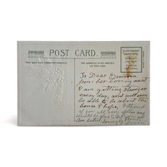 Antique embossed German New Year postcard from the 1910s featuring an open book with snowy countryside illustration, festive holly sprig, and ornate greeting text.