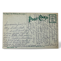 Antique 1913 New Year postcard featuring embossed four-leaf clovers, gilded scroll with greeting, and red seal motif; preserved message on reverse, marked Made in Saxony.